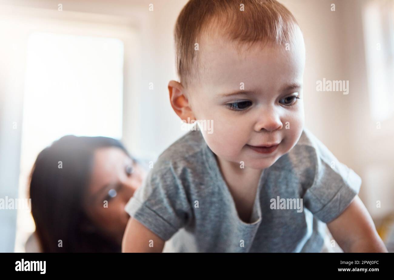 Ready or not, here I come. an adorable baby girl crawling on a bed with