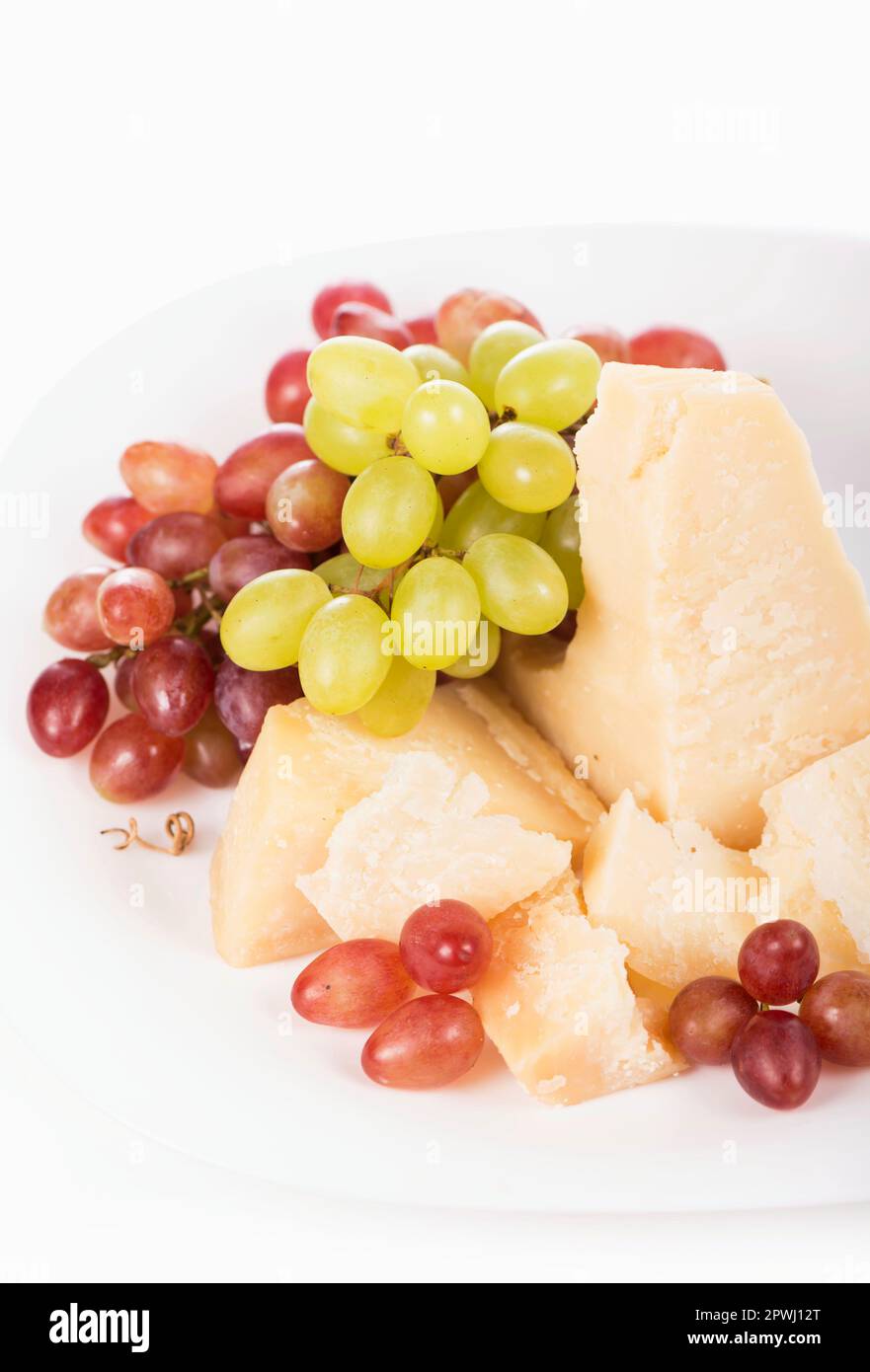 Parmesan cheese and grapes isolated on a white backgroun. View from above Stock Photo