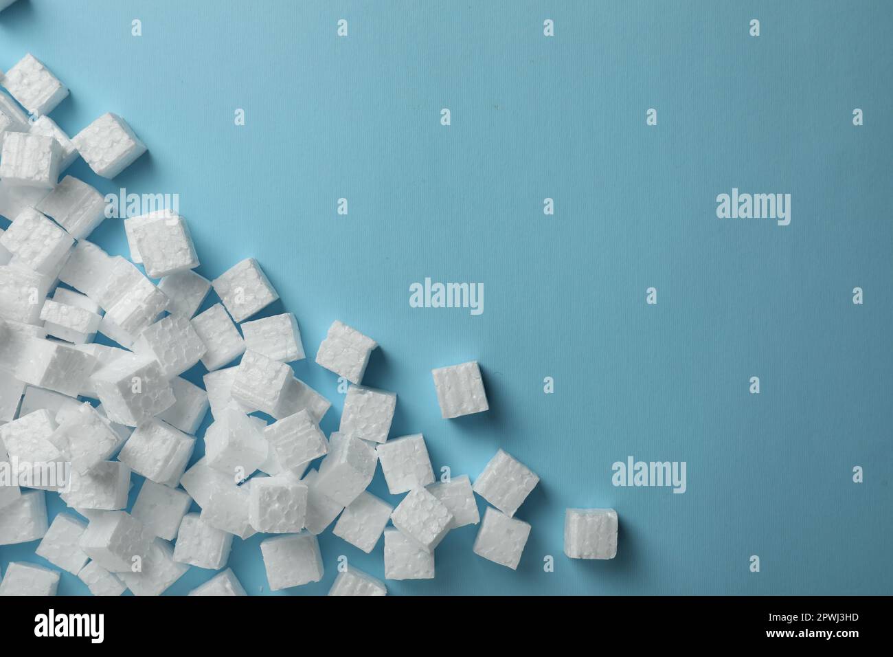 Many styrofoam cubes on light blue background, flat lay. Space for text Stock Photo