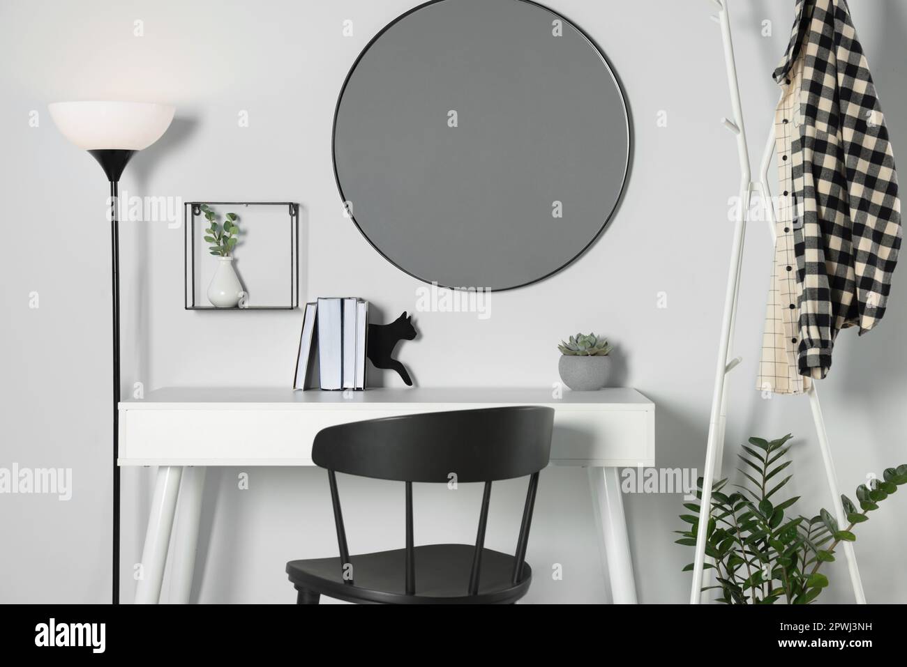 Stylish room interior with round mirror on white wall over desk Stock Photo Alamy