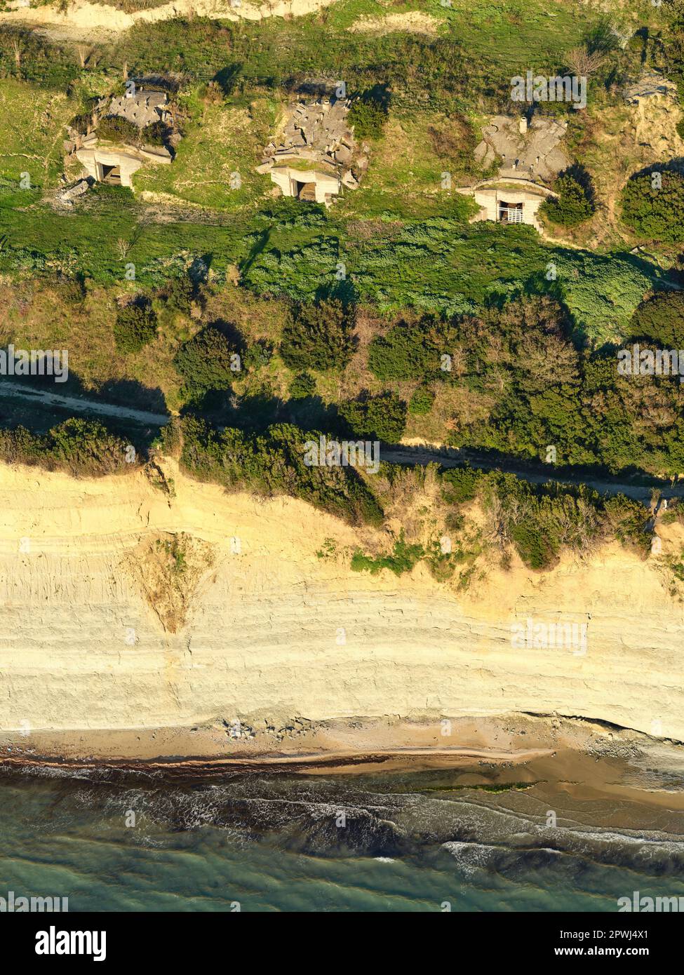 AERIAL VIEW. Three concrete bunkers on a clifftop overlooking the Adriatic Sea. Cape of Rodon, Durrës County,  Albania. Stock Photo