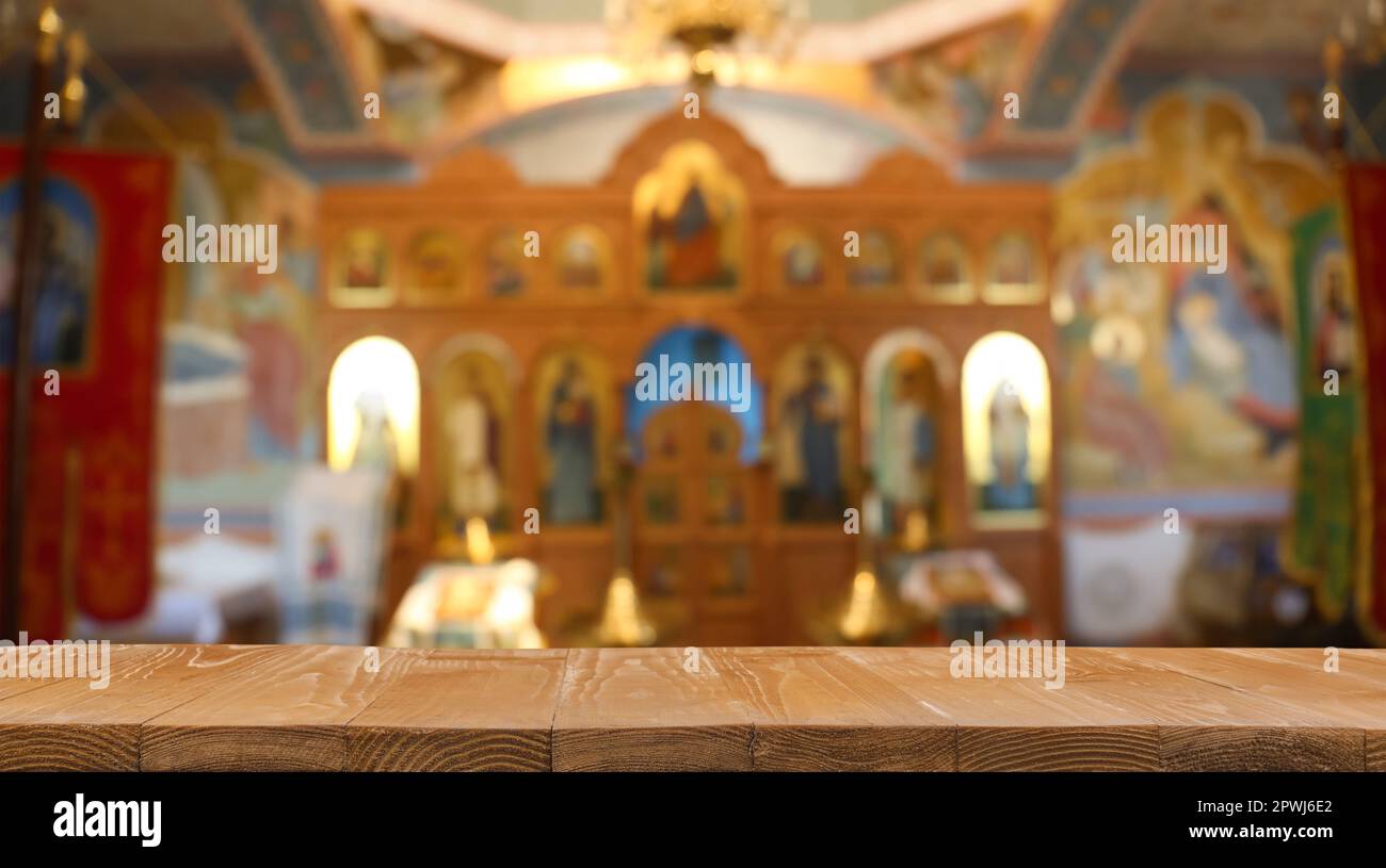 Empty Ritual Table Background Empty wooden table and blurred view of beautiful church interior, space ...