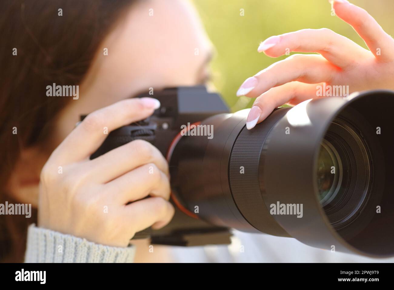 Close up portrait of a photographer using camera to take photos Stock Photo