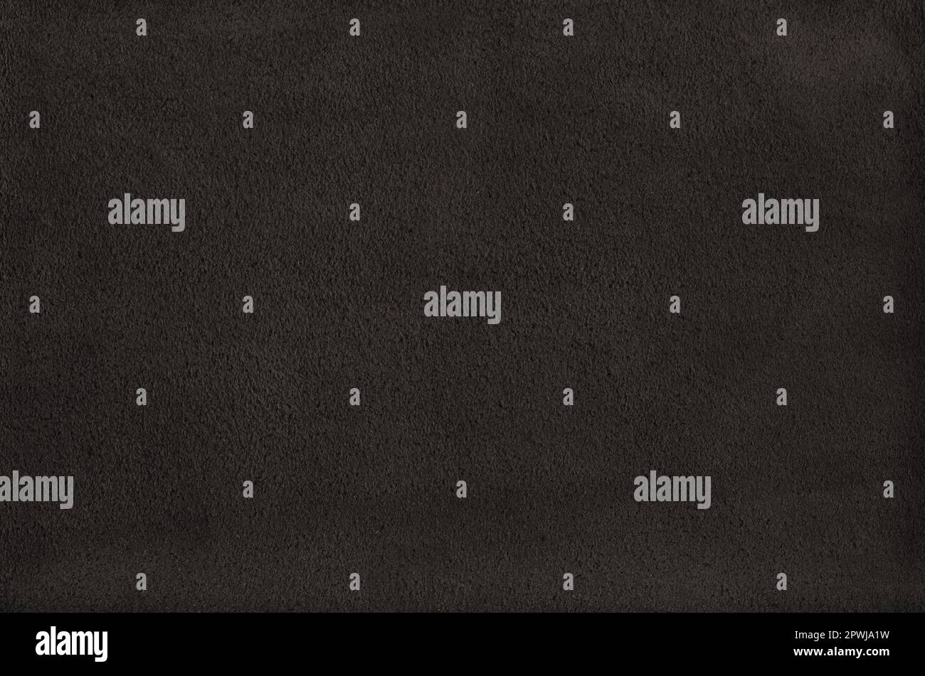 Black suede leather texture background. Natural material pattern. Stock Photo