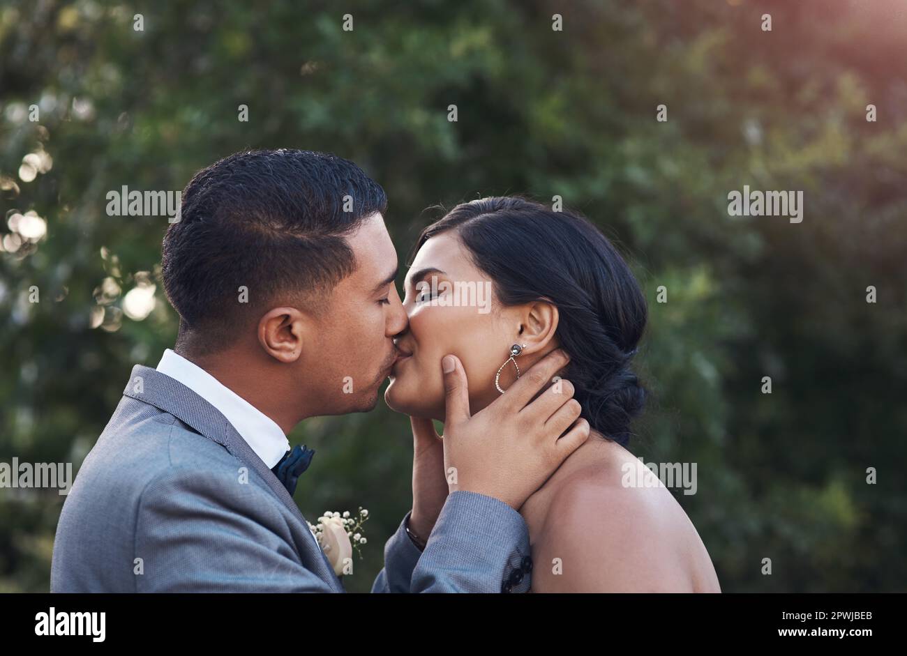 Sharing a kiss as Mr. and Mrs.a young couple sharing a kiss on their wedding day Stock Photo Alamy