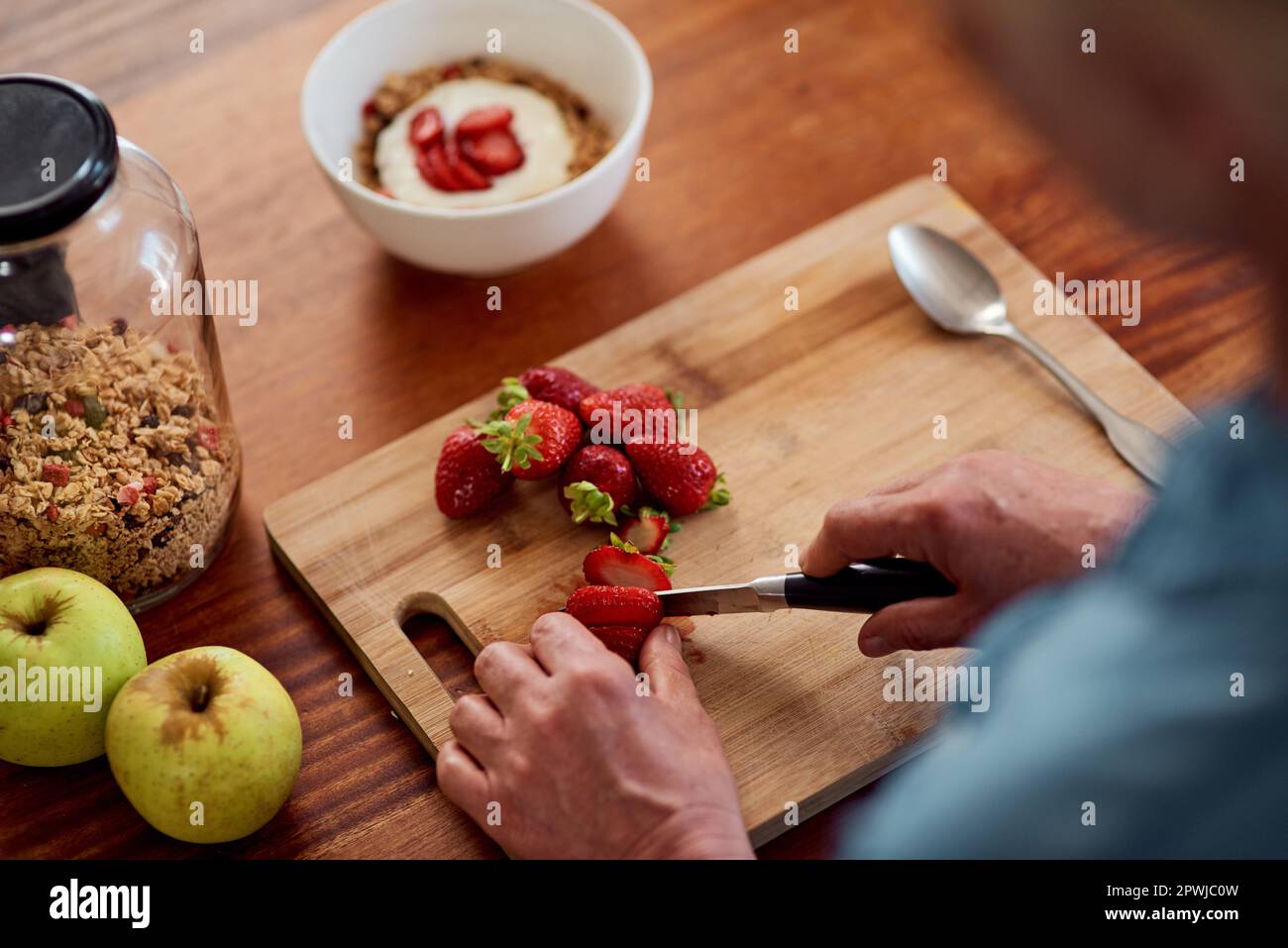 A berry healthy start to the day. an unrecognisable woman making a healthy breakfast at home Stock Photo
