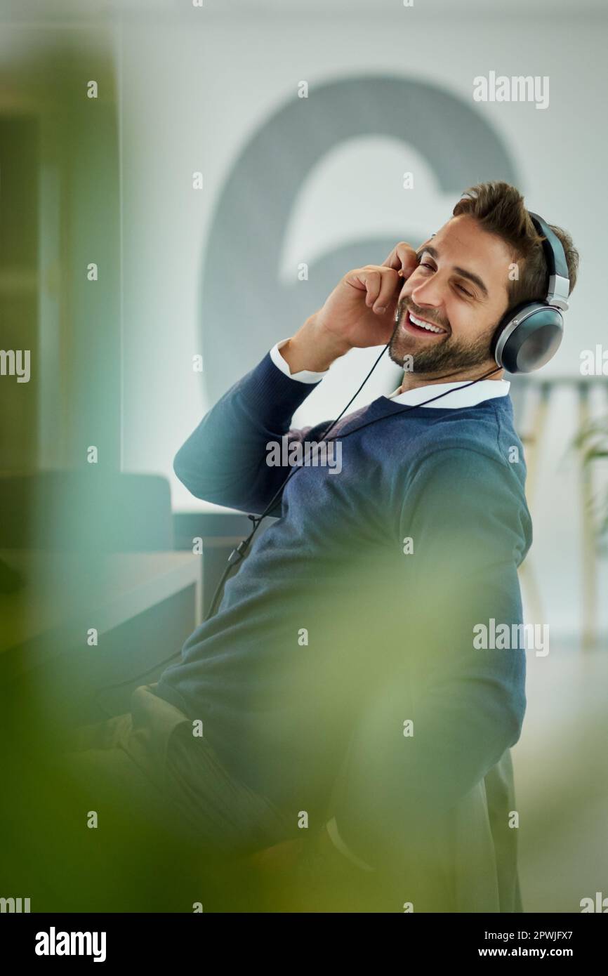 Music turns the office into a more vibrant place. a young businessman