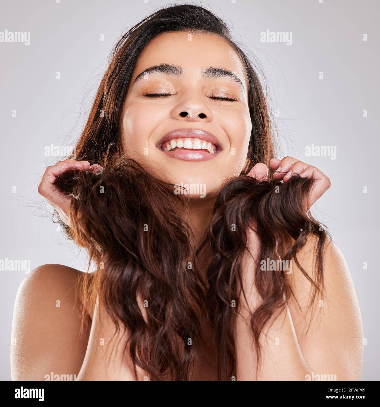 Lifes too short for unhealthy hair Studio shot of a young woman with Lifes too short for unhealthy hair Studio shot of a young woman with