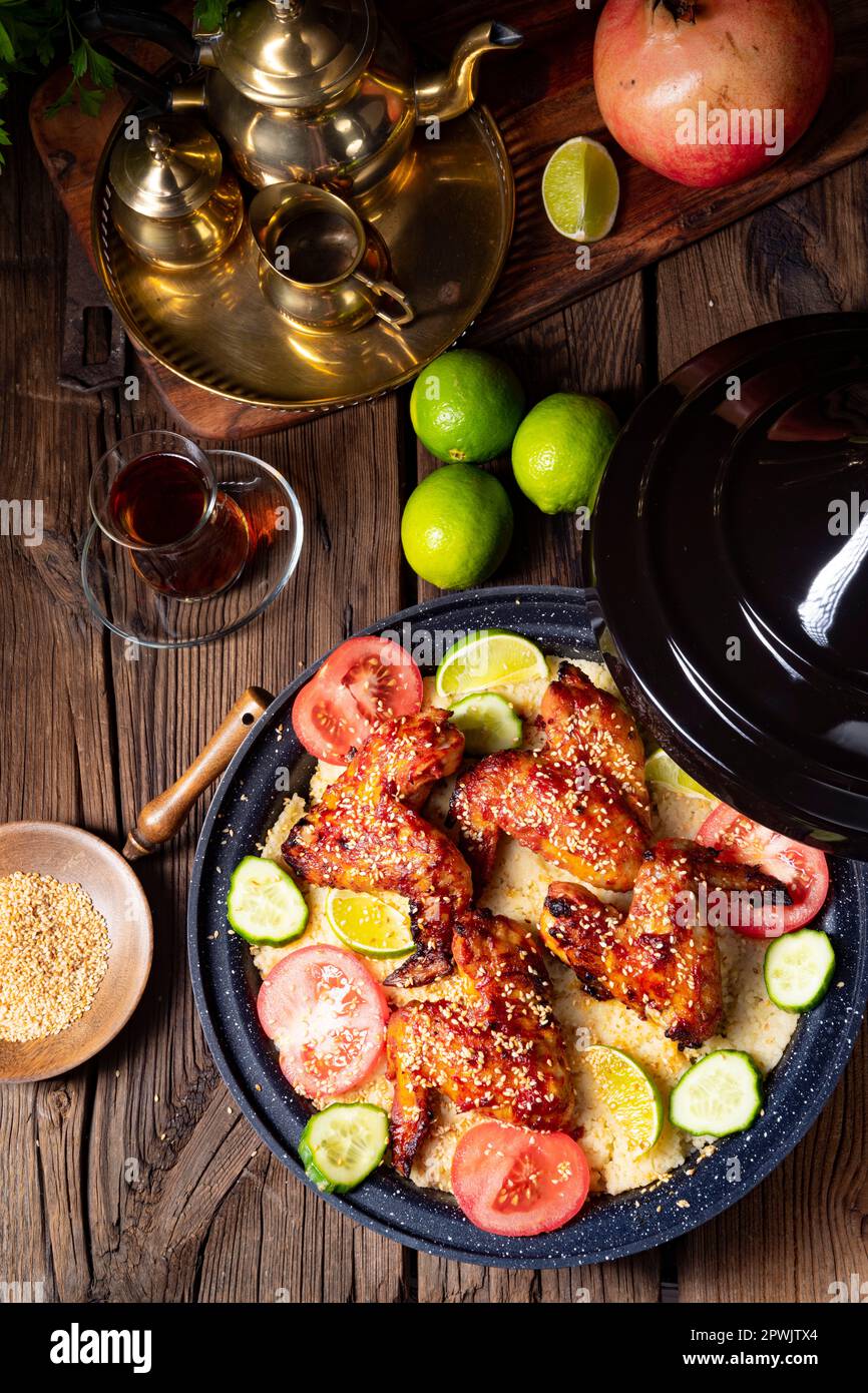 couscous with fried chicken wings spicy Stock Photo Alamy