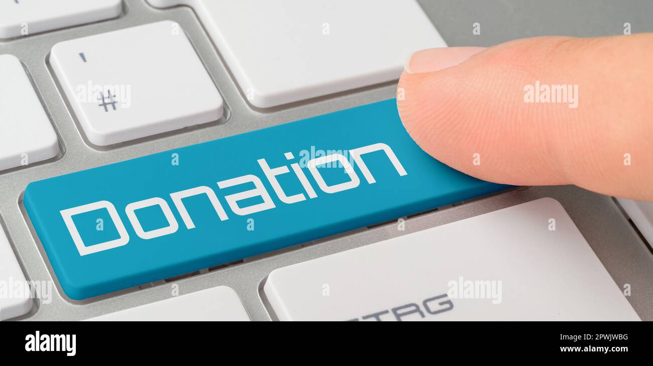 A keyboard with a blue labeled button - Donation Stock Photo