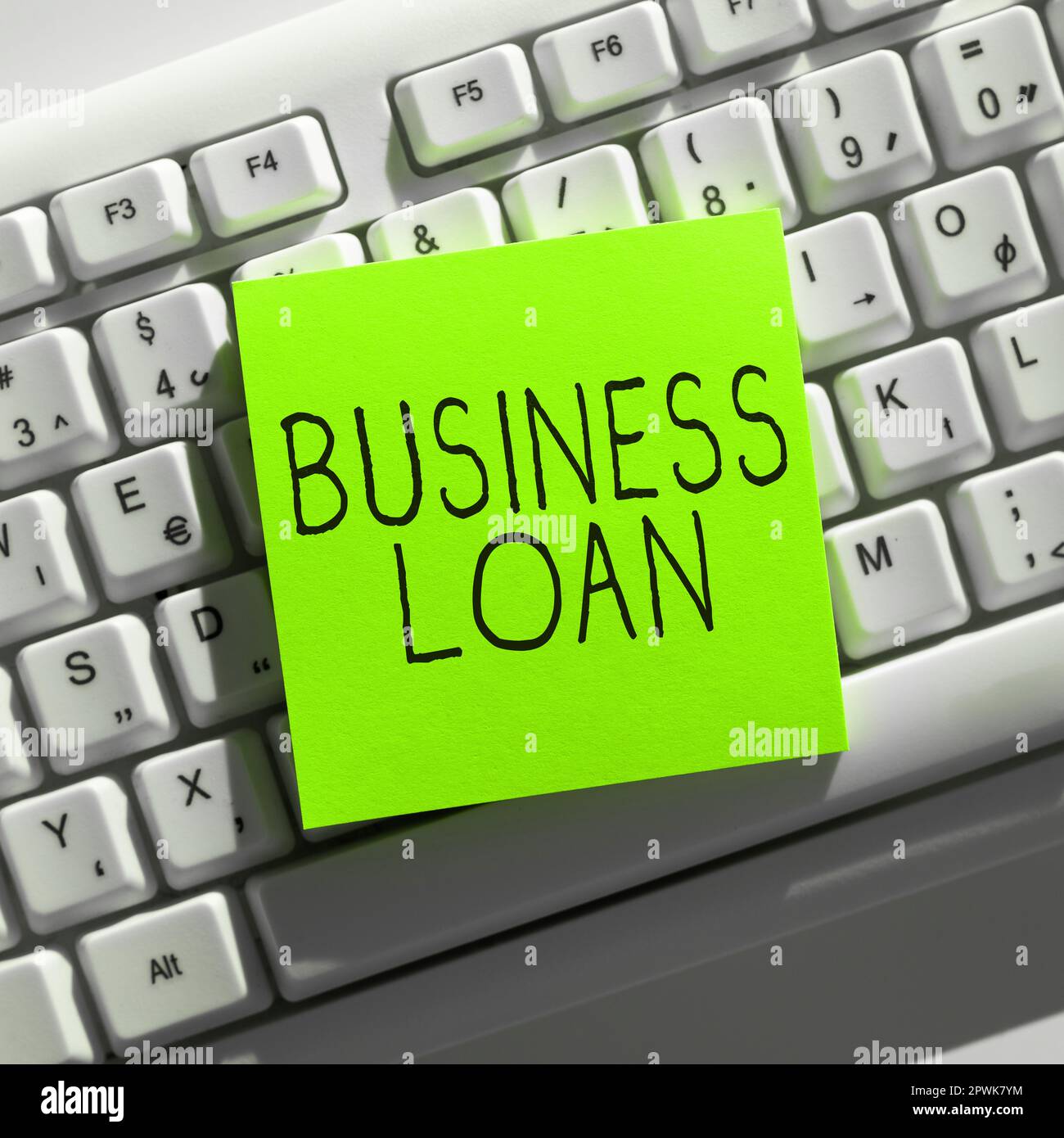 Hand writing sign Business Loan, Word for Credit Mortgage Financial Assistance Cash Advances Debt Stock Photo