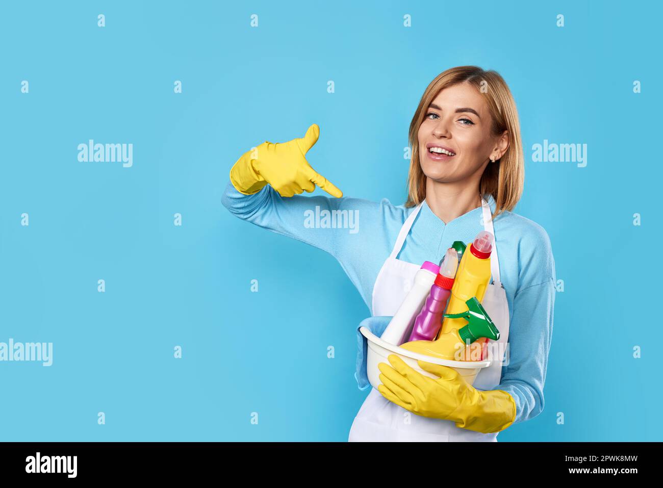 professional cleaner woman in rubber gloves pointing fingers at bucket