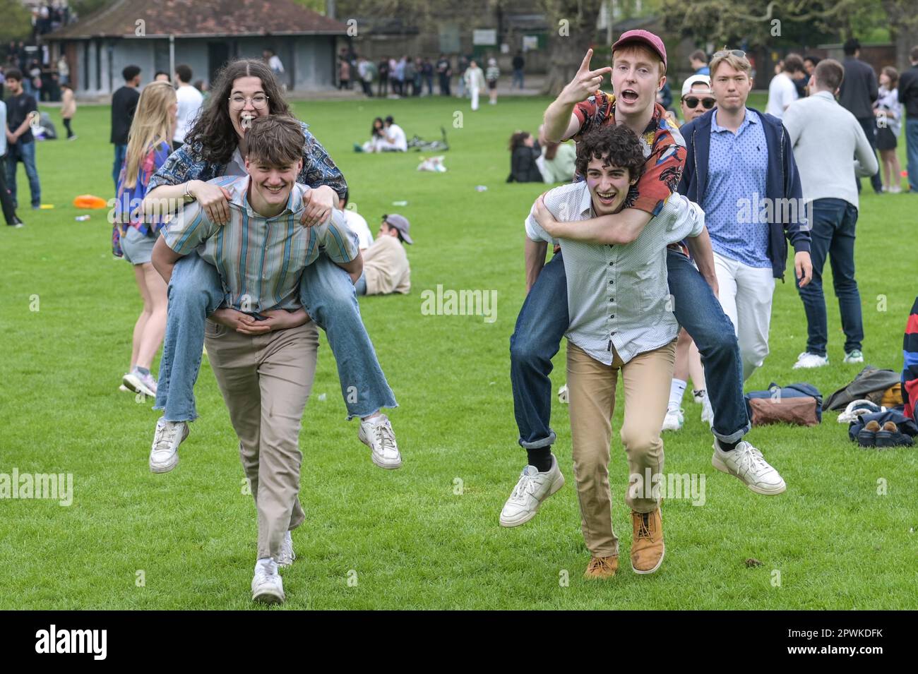 Jesus Green, Cambridge, 30th April 2023 - Hordes of Cambridge University students flocked to a park on Sunday afternoon in the Bank Holiday sunshine for the annual 'Caesarian Sunday' drinking party. Undergraduates from the prestigious institutions frolicked through the afternoon in fancy dress taking part in drinking games on Jesus Green. The tradition, also known as ‘C-Sunday' attracts thousands of students just before they take part in exams. Police were present to keep the academics in check. With some revellers needing assistance from paramedics after various mishaps. Credit: Stop Press Me Stock Photo