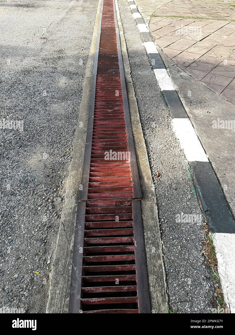 water drain or ditch on the road. Gutters drain grate, drain cover. Road drains - sewer cover. iron grate of water drain on the road in every city. Wa Stock Photo