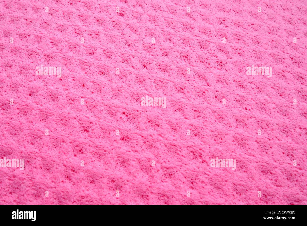 Sponge fibers sponge texture pattern surface close-up pink magenta background. Stock Photo