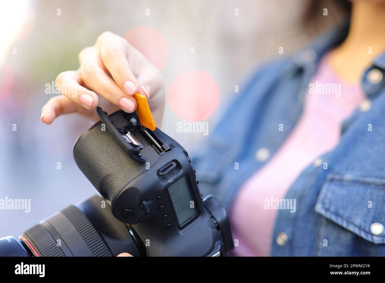 Close up portrait of a photographer hand inserting memory card on
