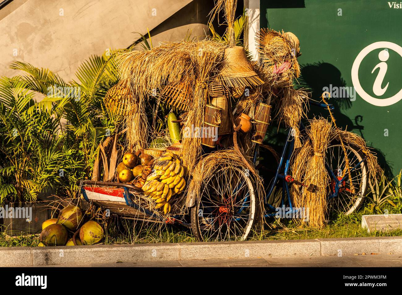 a cyclo decked out w/ traditional offerings for The Cambodian New Year