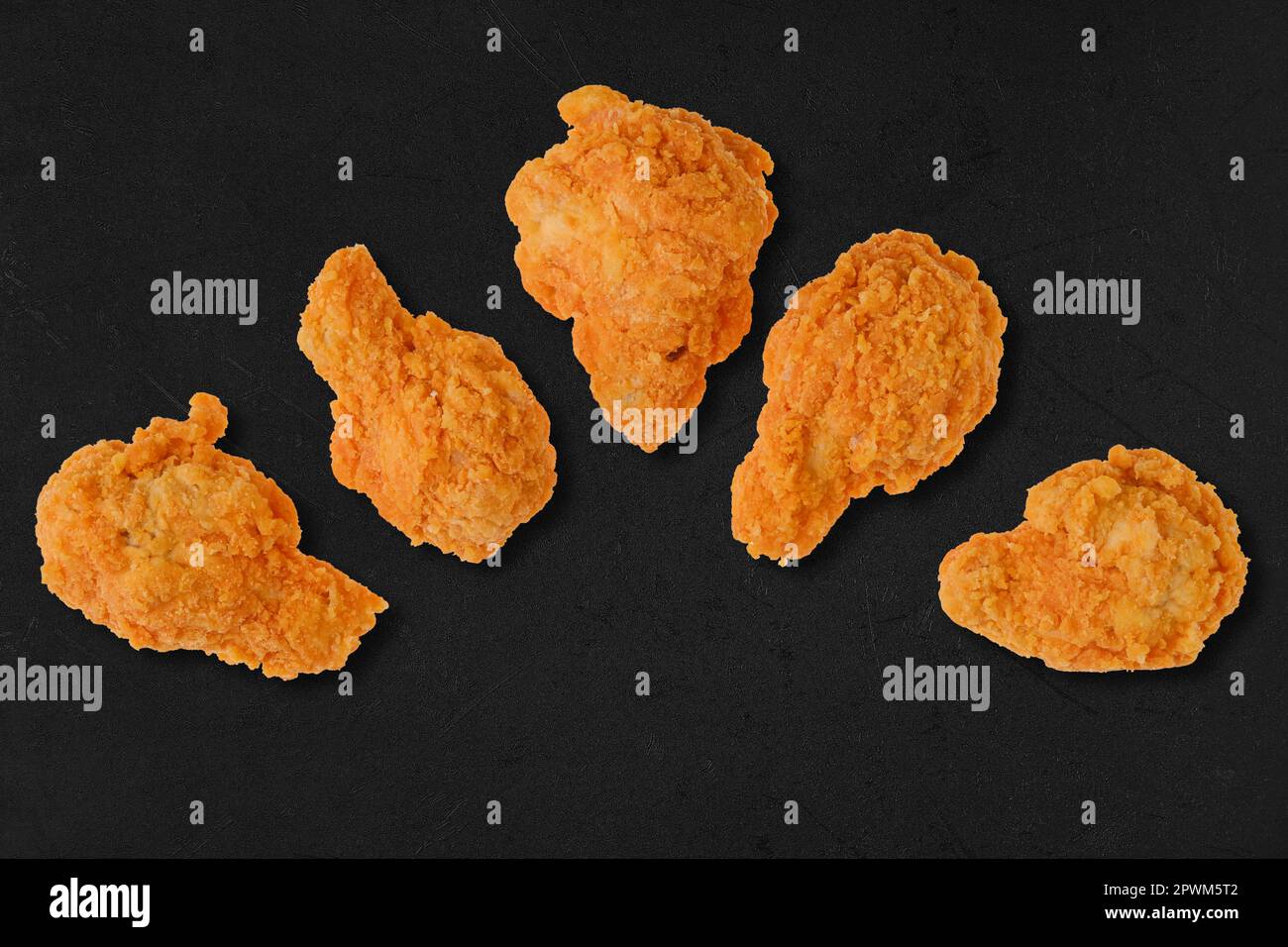 Top view of semifinished frozen chicken drumsticks ready for deep