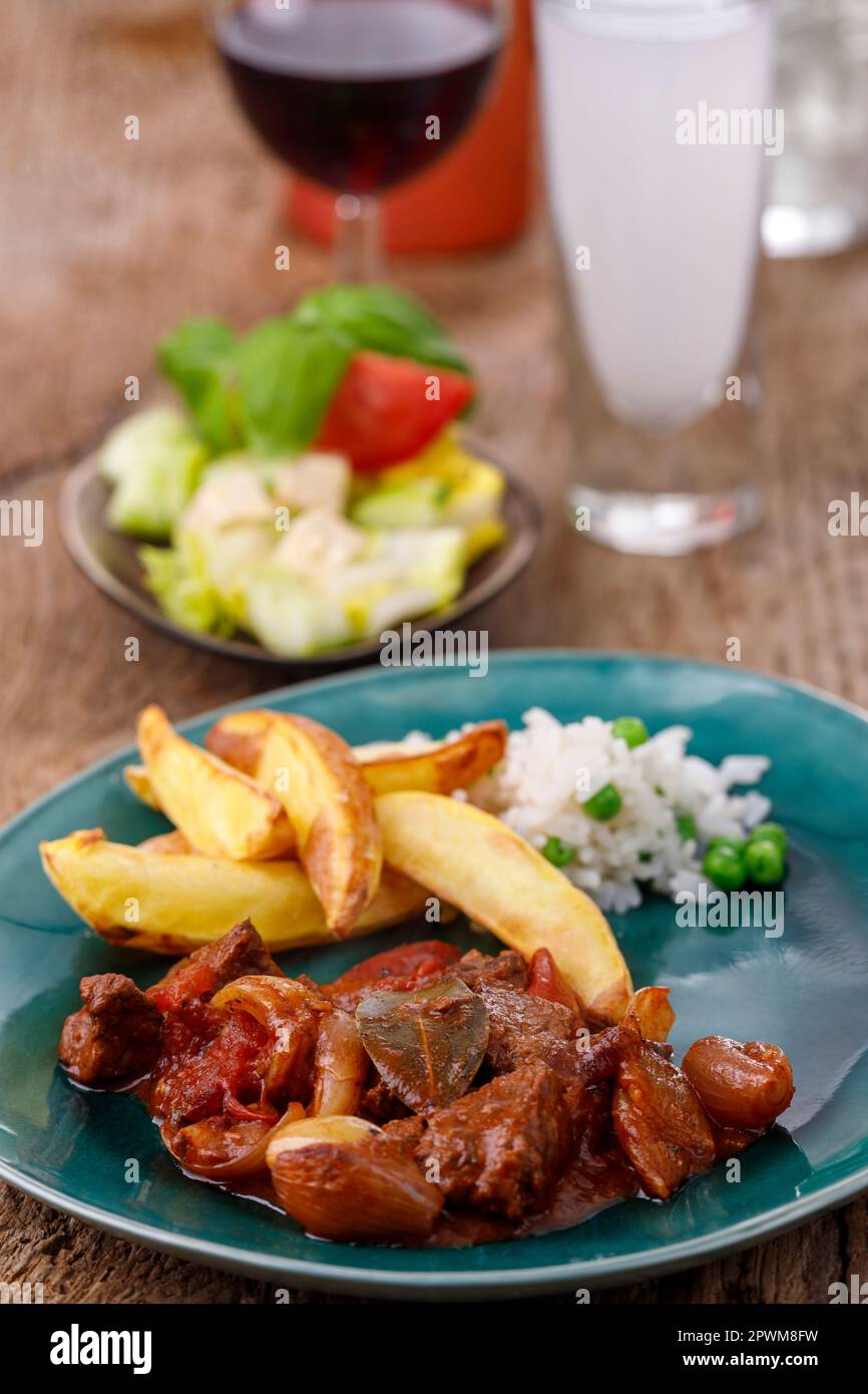 greek stifado meat stew with fries Stock Photo Alamy