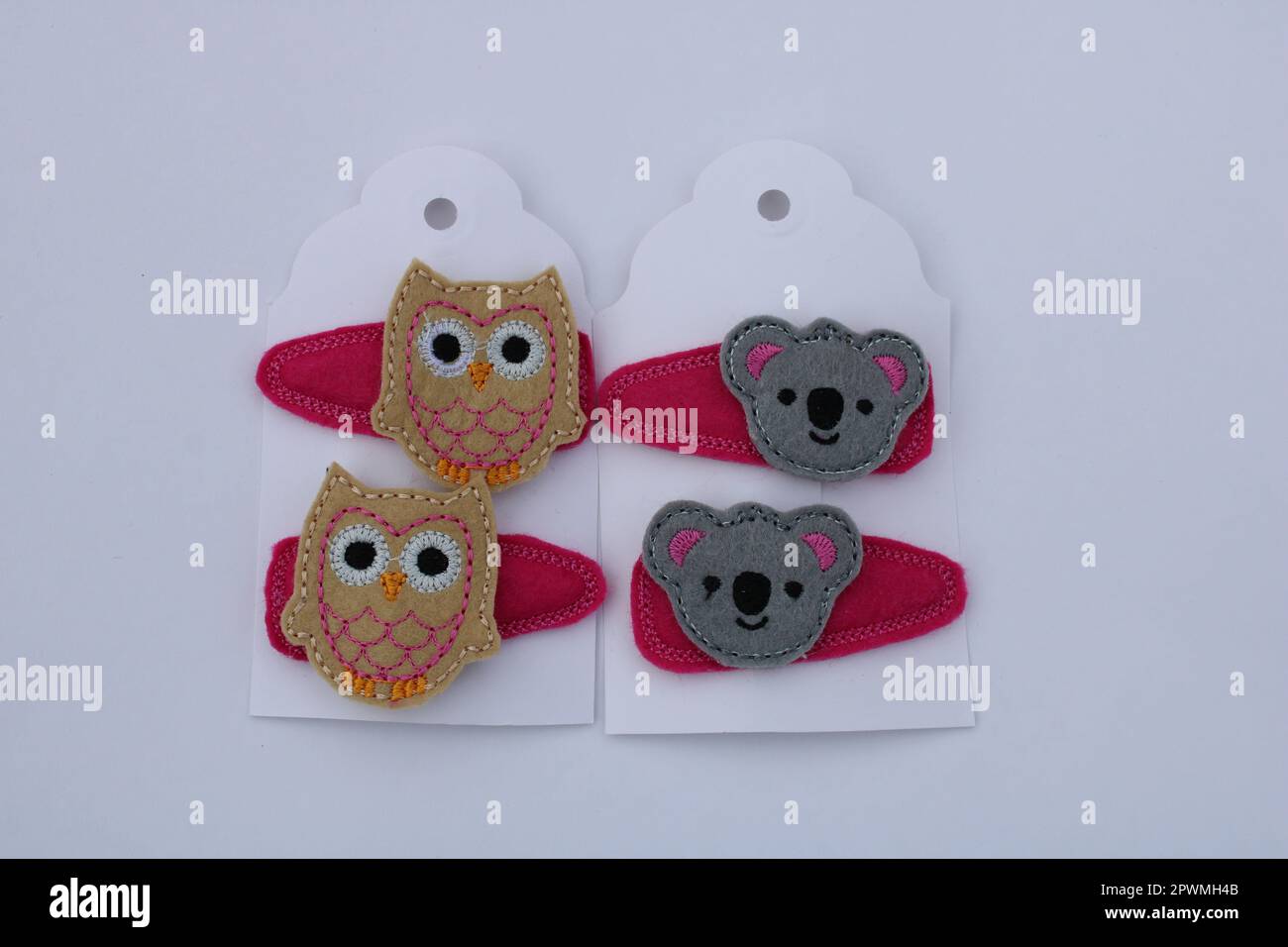 Home made embroidered animal hair clips of an Owl and Koala bear Stock Photo