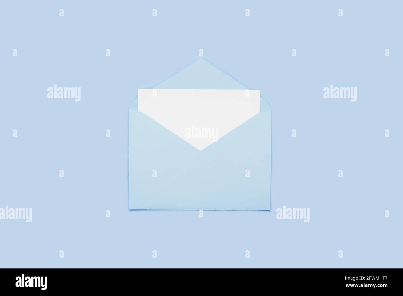 Empty Envelope Card Closeup on blank empty white paper card in blue opened envelope ...