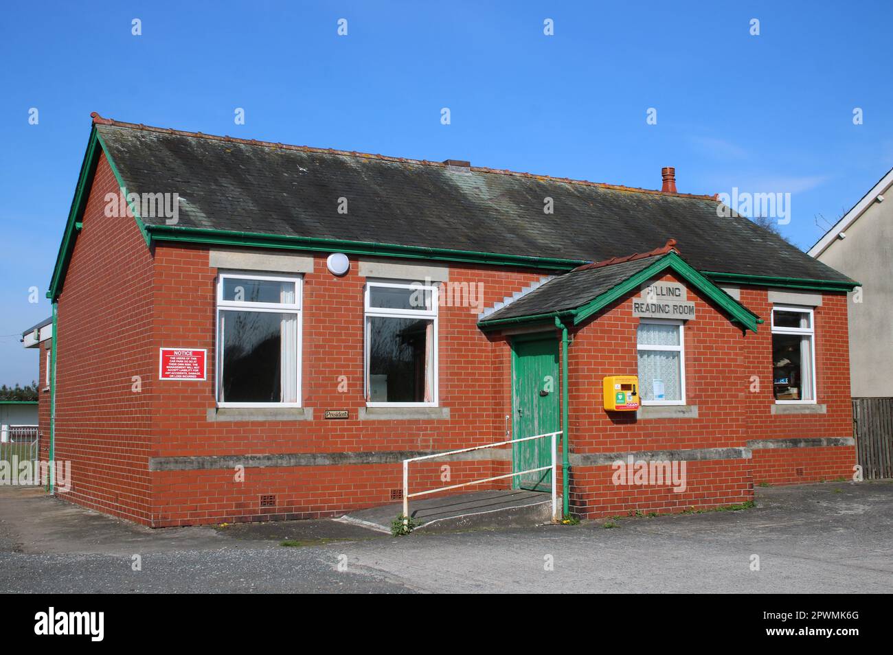 Pilling Reading Room building with emergency defibrillator on the wall, School Lane, Pilling, Preston, Lancashire. Stock Photo