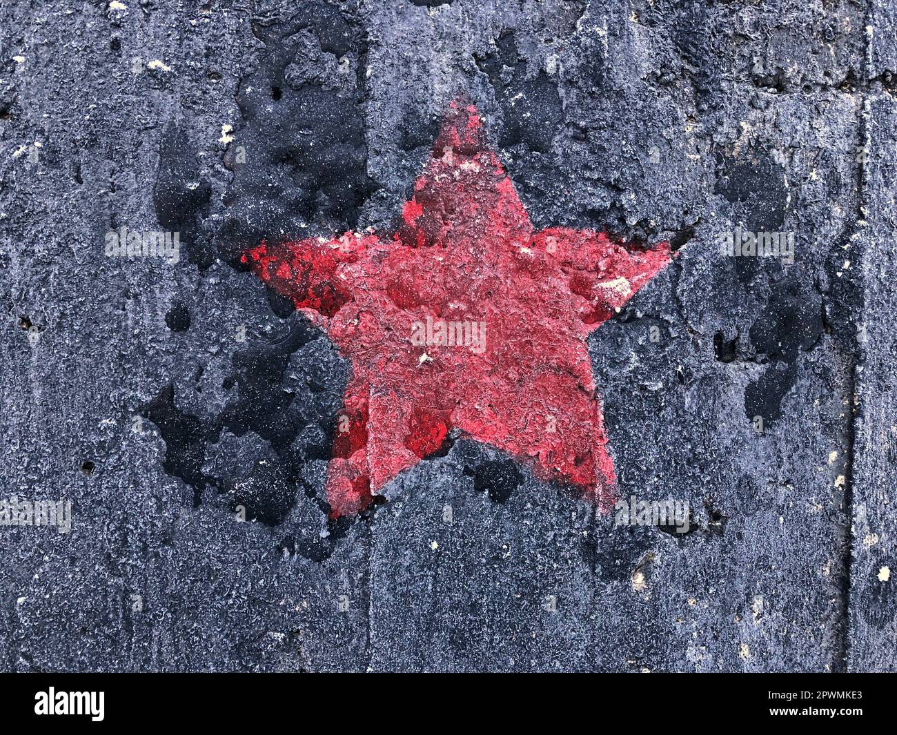 red five-pointed star on a black shabby background Stock Photo