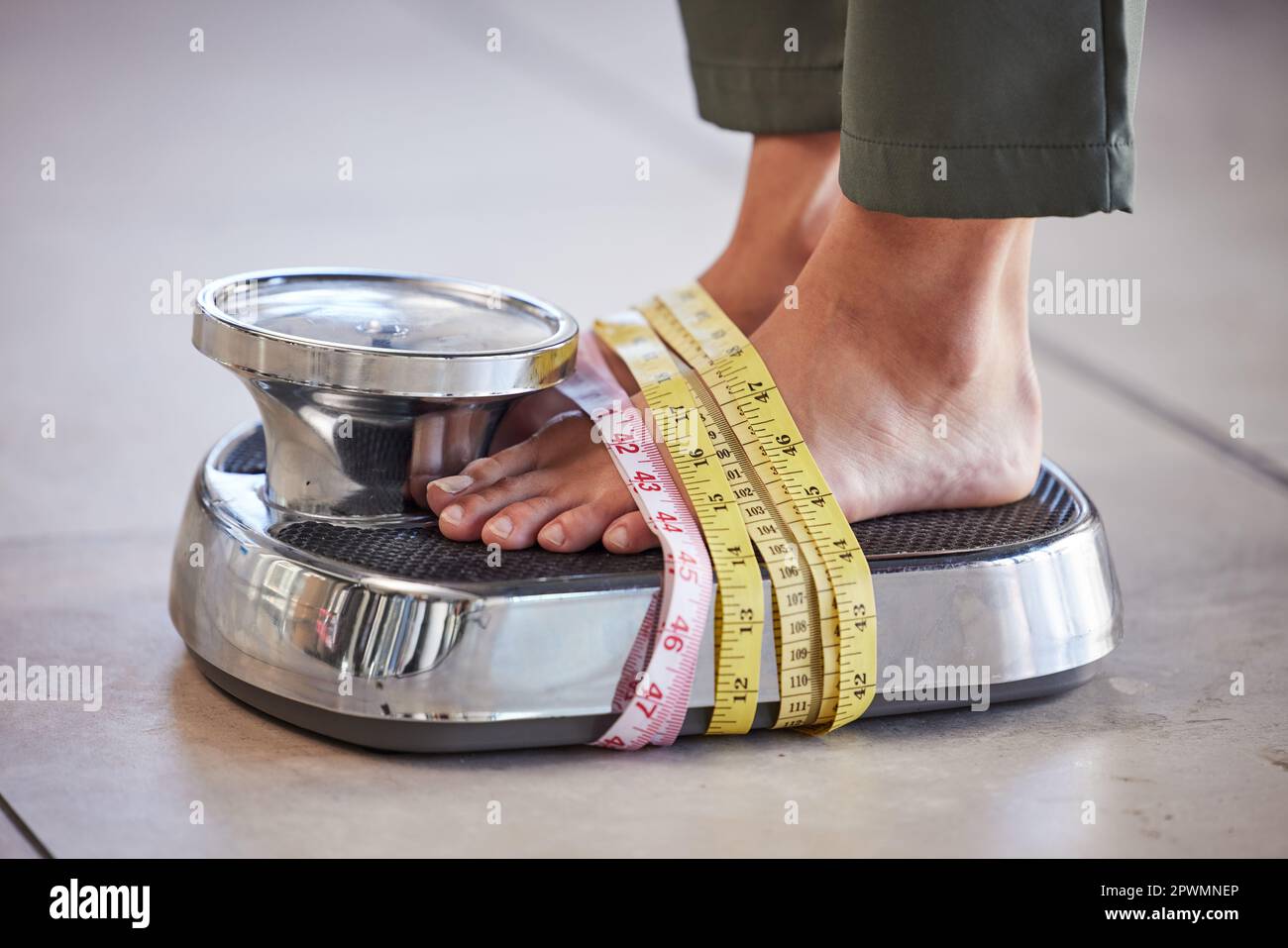 Diet, weight loss and feet of a woman on a scale for body check