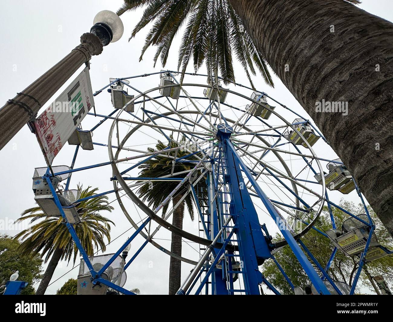 Isla Vista, California, USA. 30th Apr, 2023. Pardall Carnival In Isla Vista (Goleta) California brings together UCSB students, families and community members to promote University of California Santa Barbara student organizations and wellness. A sign Says 'Live'', a Palm Tree and a Ferris wheel. (Credit Image: © Amy Katz/ZUMA Press Wire) EDITORIAL USAGE ONLY! Not for Commercial USAGE! Credit: ZUMA Press, Inc./Alamy Live News Stock Photo