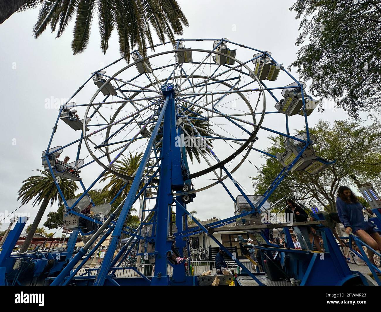 Isla Vista, California, USA. 30th Apr, 2023. Pardall Carnival In Isla Vista (Goleta) California brings together UCSB students, families and community members to promote University of California Santa Barbara student organizations and wellness. Palm Trees and a Ferris wheel. (Credit Image: © Amy Katz/ZUMA Press Wire) EDITORIAL USAGE ONLY! Not for Commercial USAGE! Credit: ZUMA Press, Inc./Alamy Live News Stock Photo