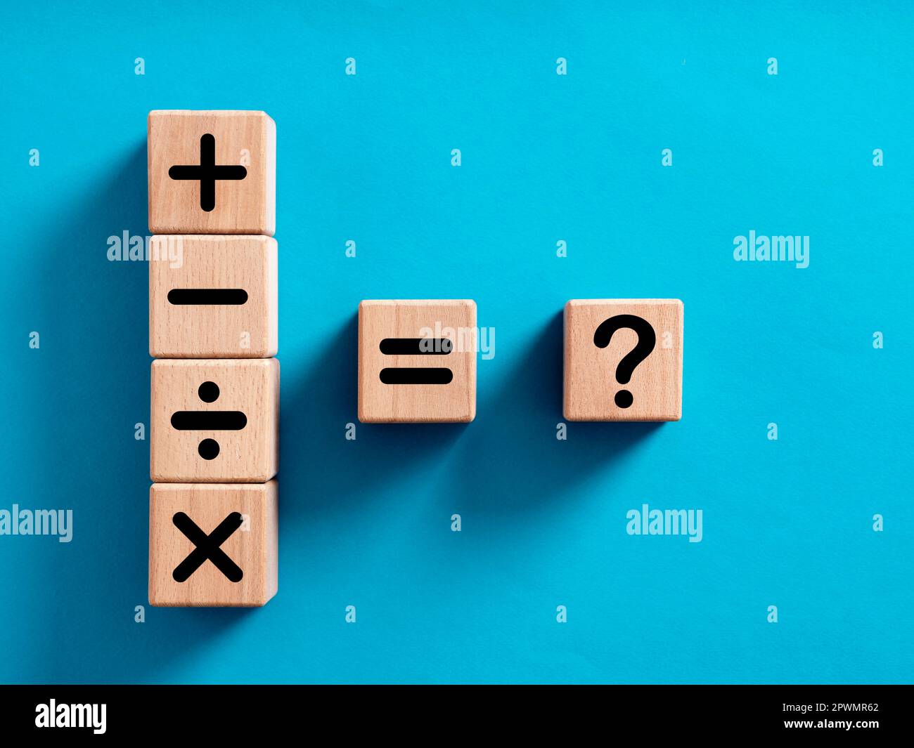 Basic mathematical operations symbols. Plus, minus, multiply, divide, equal and question mark symbols on wooden cubes. Mathematic or math action, educ Stock Photo