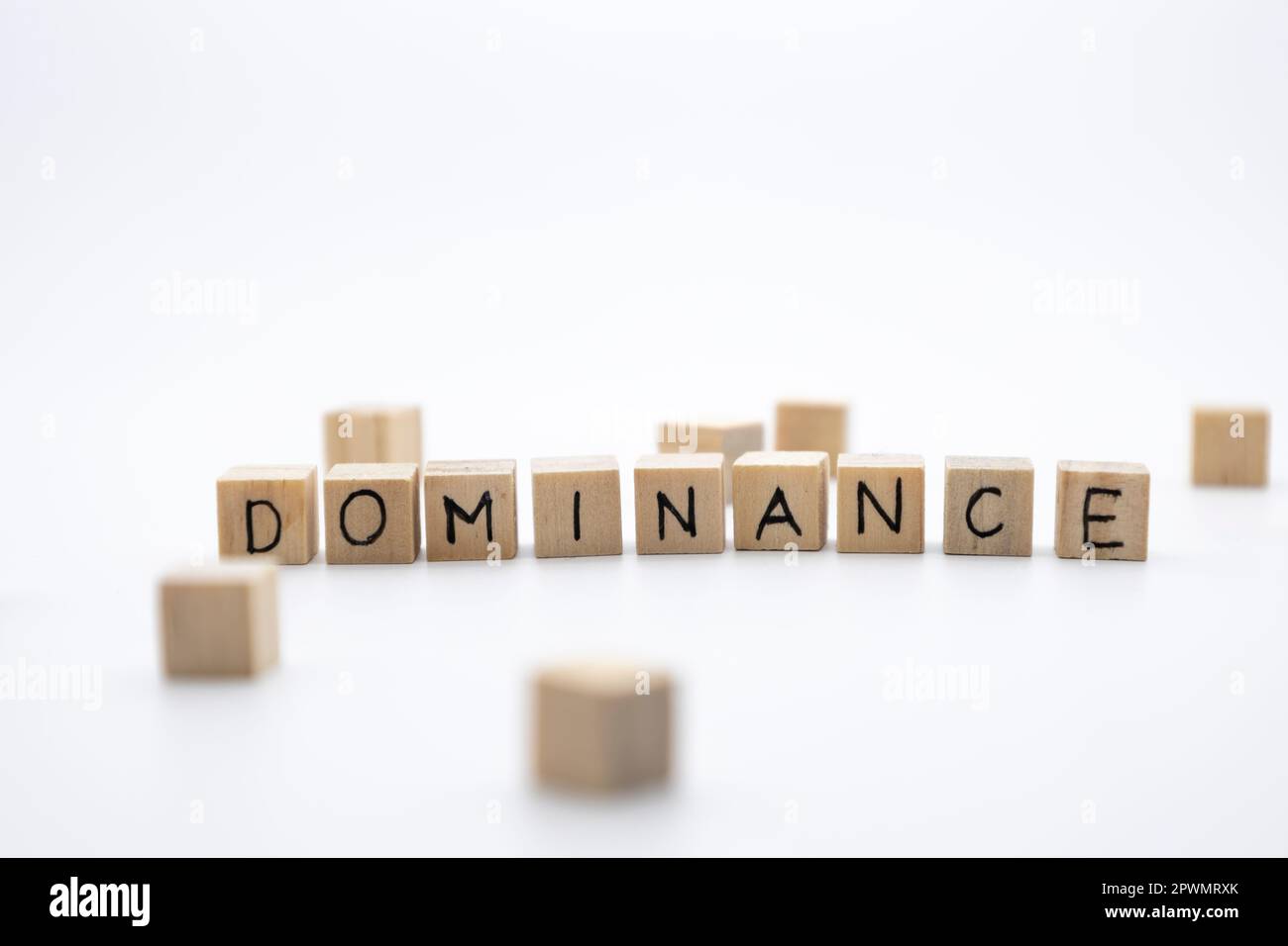 The wooden cubes with the word DOMINANCE against white background. Business, domination concept. Stock Photo