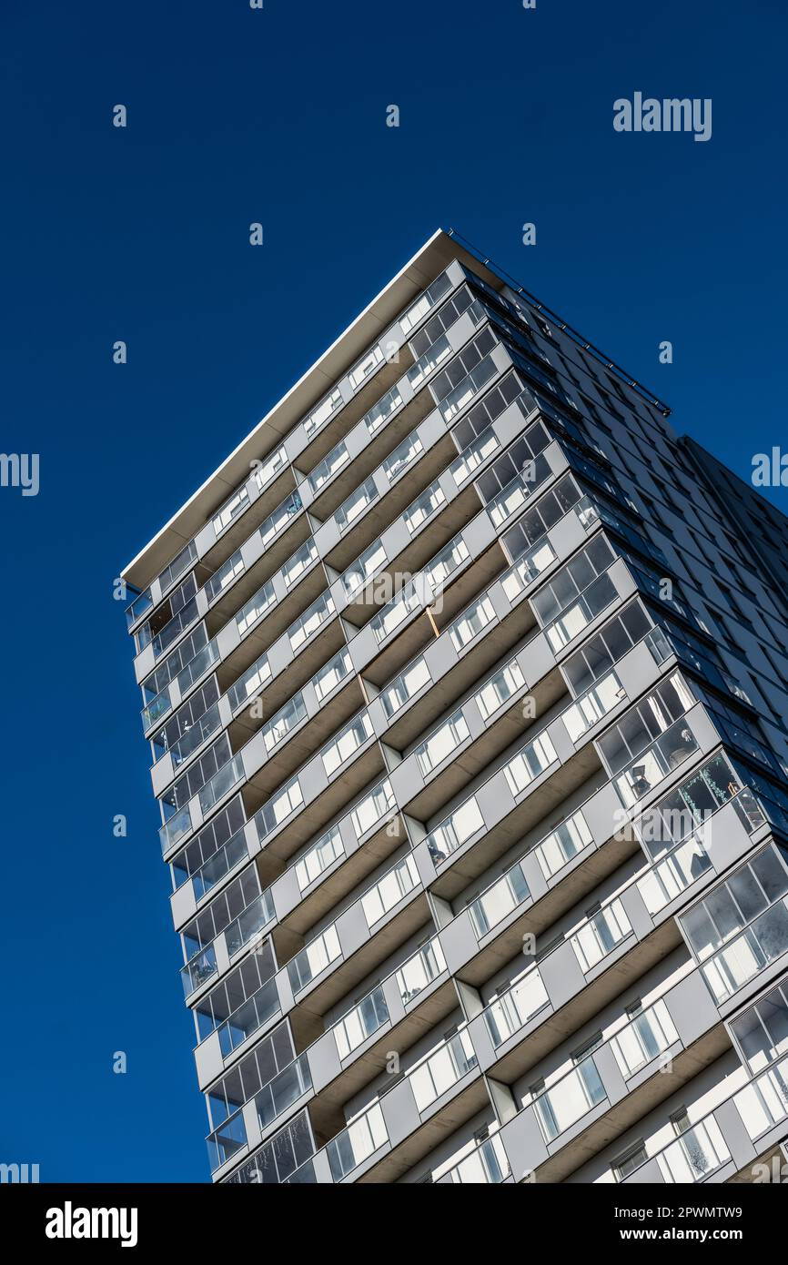 High rise apartment building against blue sky Stock Photo - Alamy