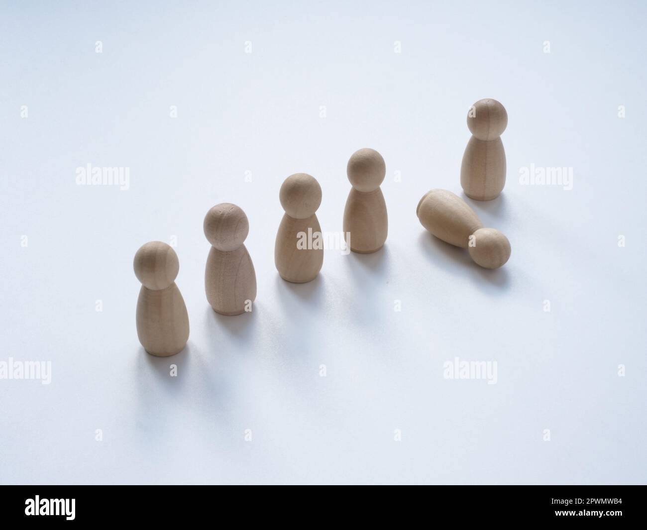 Burnout or exhaustion concept. A number of figurines and one fell. Stock Photo