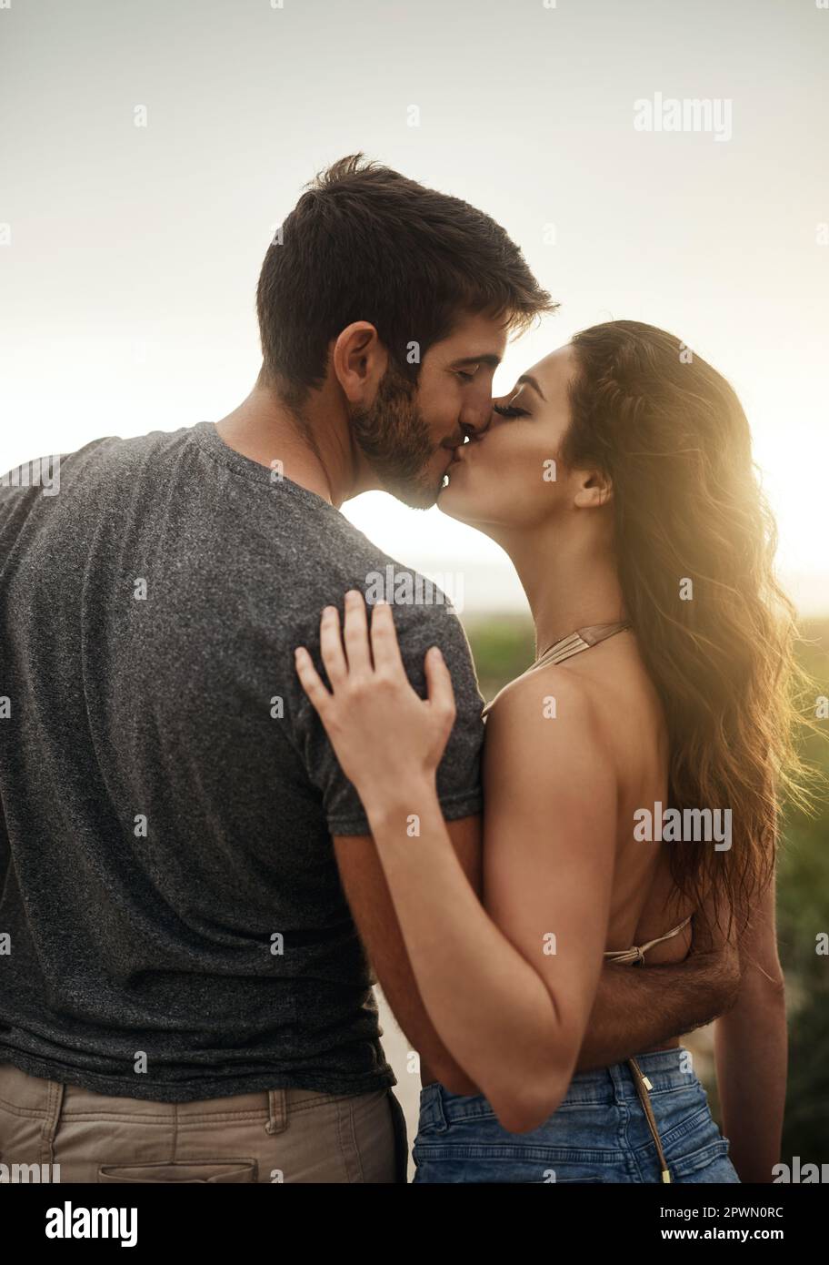 Kiss me and youll see how much I love you. Rearview shot of a young couple  kissing at the beach Stock Photo - Alamy