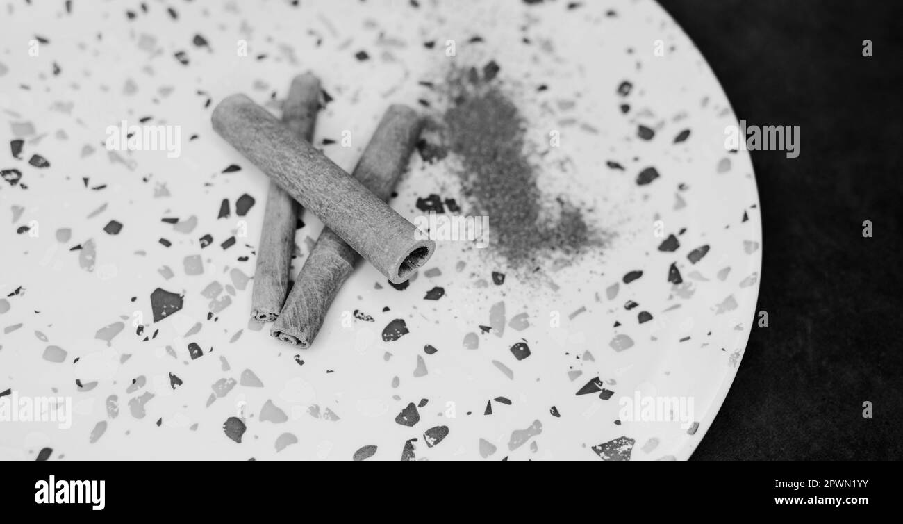 Cinnamon sticks and powder on plate.  natural  ingredient for culinary Stock Photo