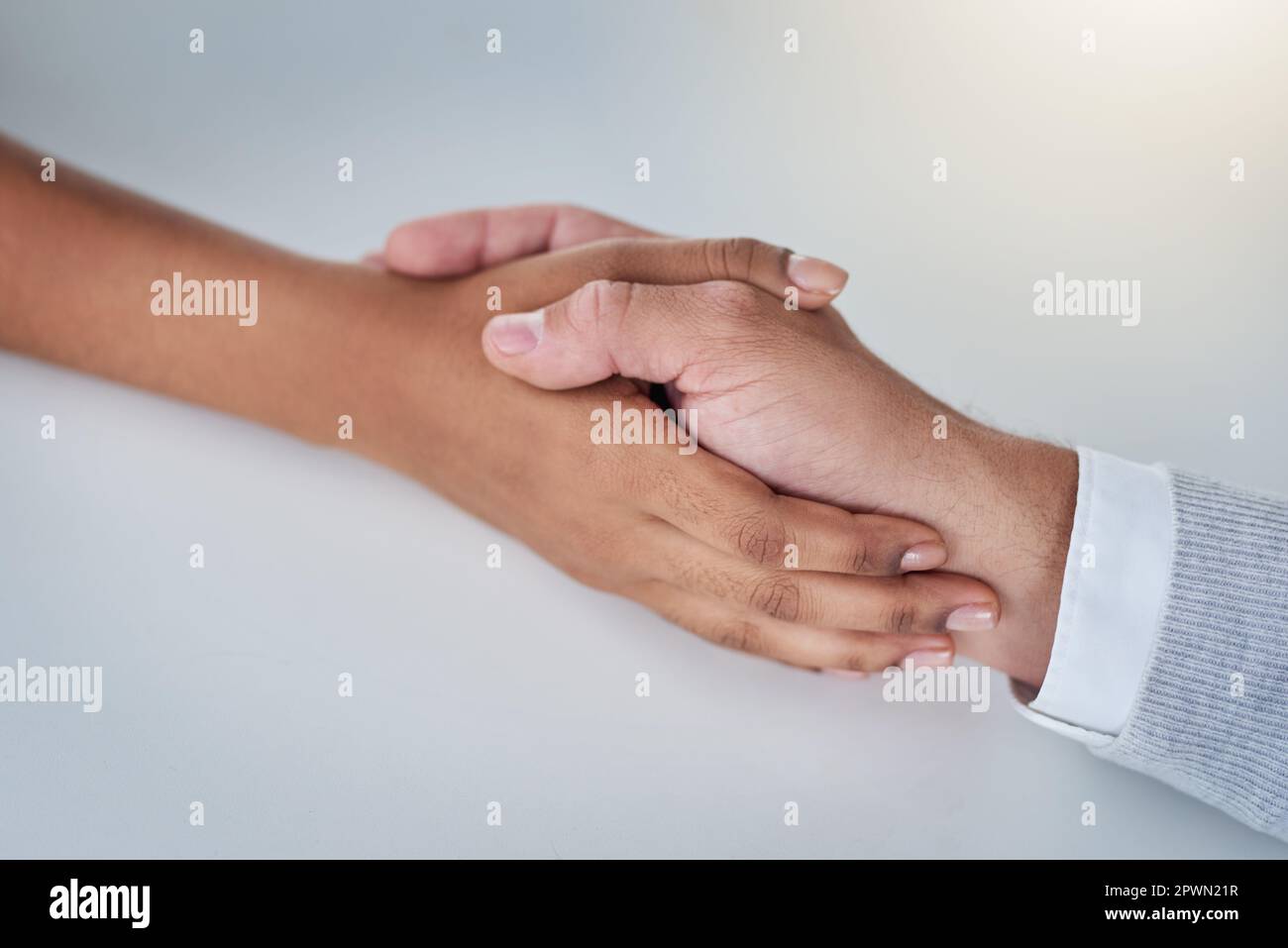 One hand washes the other. a businessman and businesswoman compassionately holding hands at a