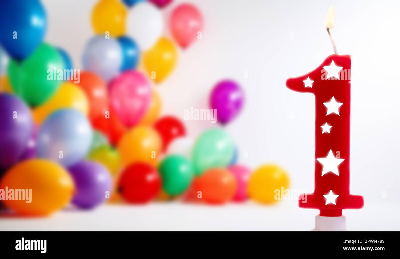 Number 1 birthday celebration candle against a bright white background