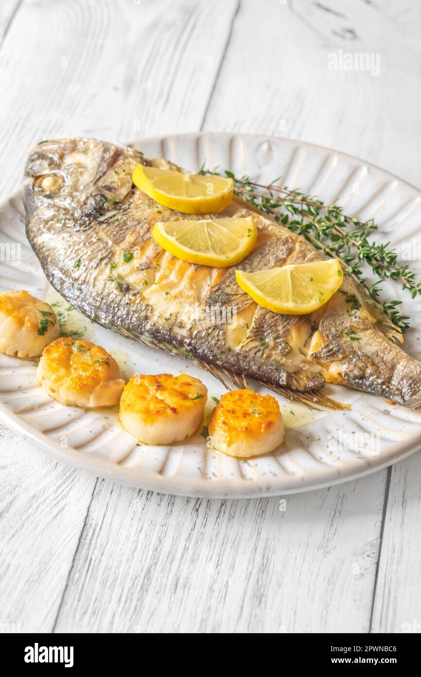 Mediterranean Baked Sea Bream Dorada fish with scallops and thyme Stock ...