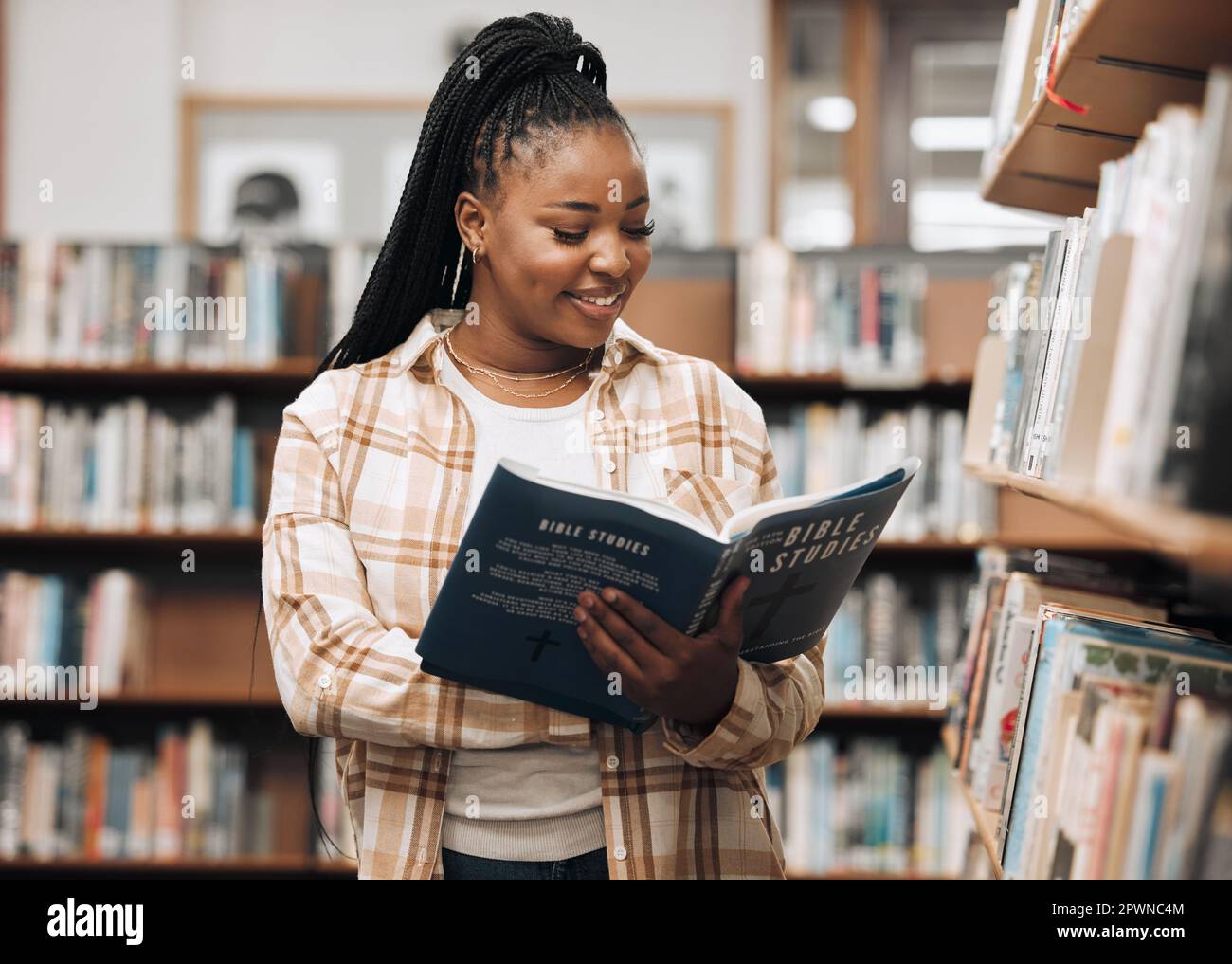 Black woman, library and reading for knowledge, education and relax. Nigerian female, girl and
