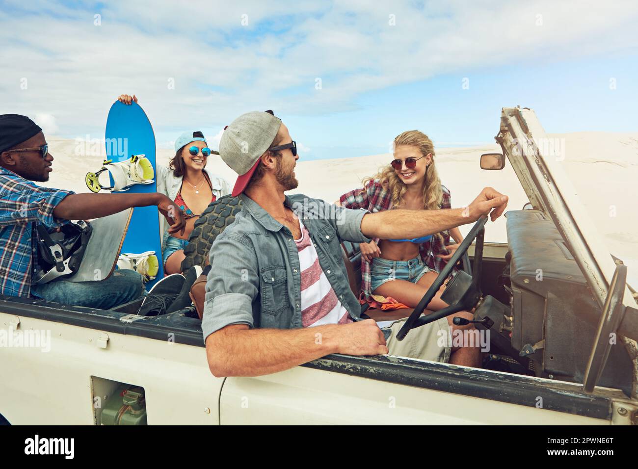 Theyre all about that road trip life. a group of young friends going on a sand boarding road trip in the desert. Stock Photo