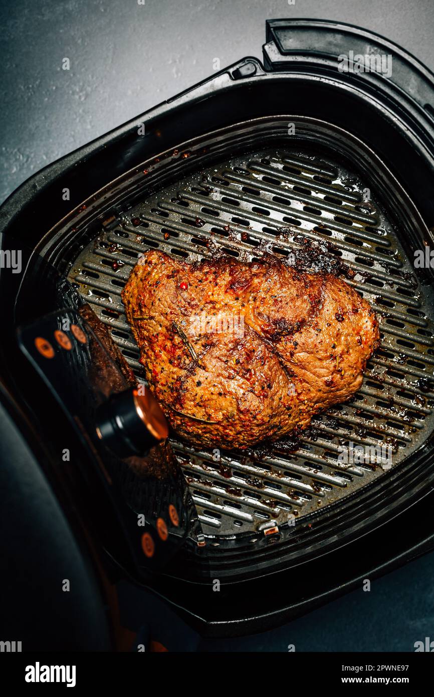 Grilled flank beef steak with rosemary, prepared in airfryer Stock