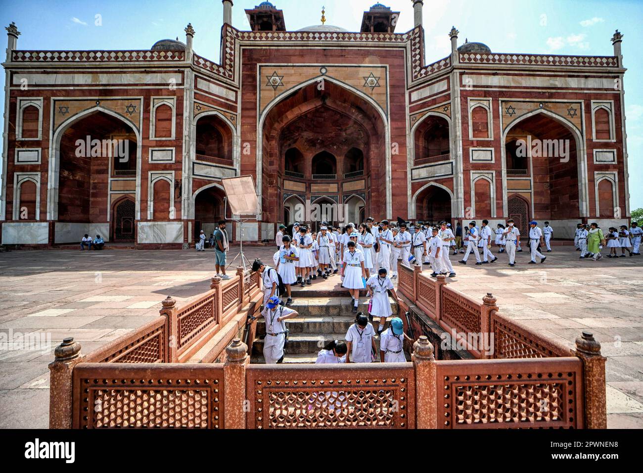 School students seen on an Educational tour at the Humayun Tomb in New Delhi. Humayun’s Tomb is a grand dynastic mausoleum that was to become synonyms of Mughal architecture. The mausoleum was completed in the year 1570 and contains the tombs of Emperor Humayun as well Bega Begum, Hamida Begum, and Dara Shikoh. The tomb was the first garden-tomb on the Indian subcontinent. Stock Photo