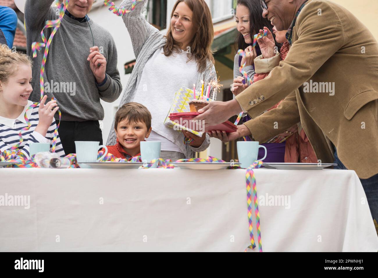 Family celebrating little boy's birthday with cake, Bavaria, Germany Stock Photo