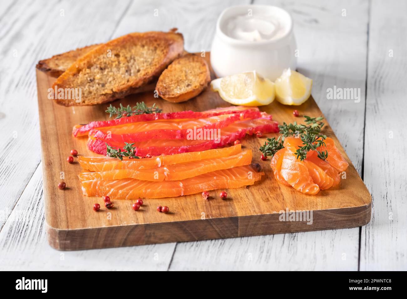 Salmon gravlax with sour cream, lemon and baguette Stock Photo Alamy