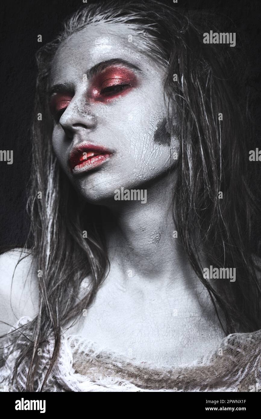 Girl in the form of zombies, Halloween corpse with blood on his lips. Image for a horror film