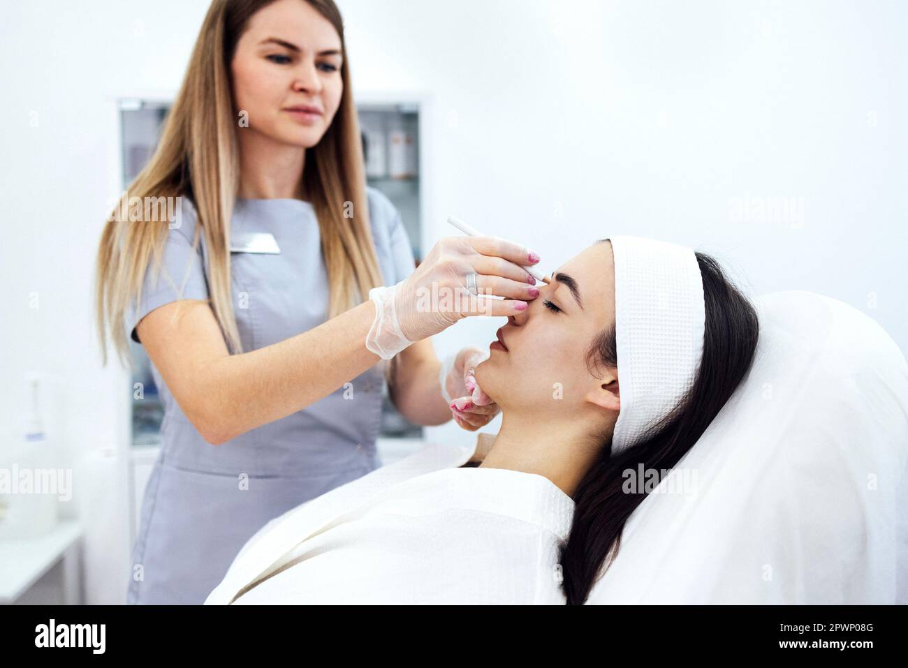 Beauty injections. Female cosmetologist in transparent gloves makes an