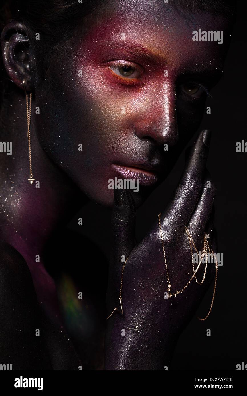 Beautiful girl with art space makeup on her face and body. Glitter Face