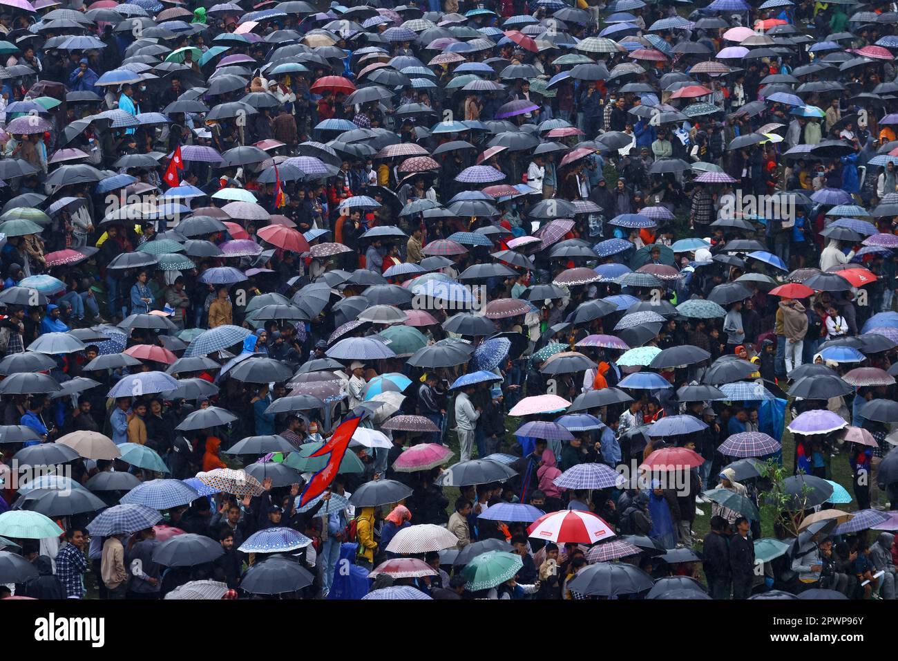 Kathmandu, NE, Nepal. 1st May, 2023. Nepali cricket fans use umbrellas