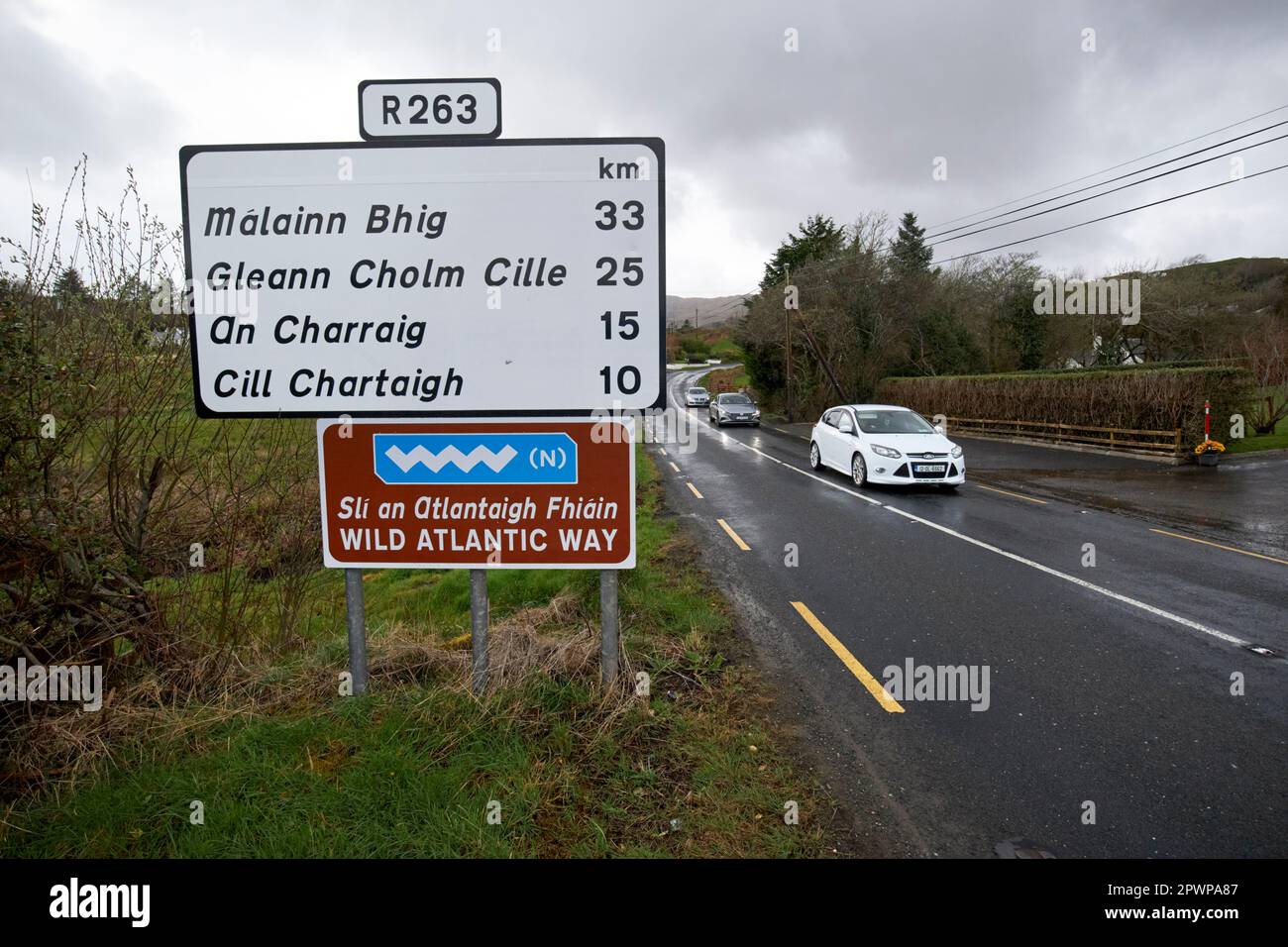 cars driving along the R263 wild atlantic way road on a wet overcast day in the gaeltacht area of county donegal republic of ireland Stock Photo